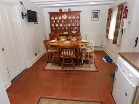 A dining room with a table and chairs at Milk Wood Cottage in Laugharne