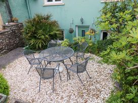 A garden with a table and chairs at Milk Wood Cottage in Laugharne
