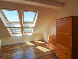 A room with four skylight windows and wooden furniture at Curraha in Lauragh County Kerry