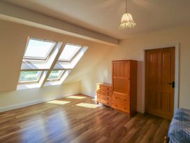 A room with wooden floor skylight windows wooden cabinet dresser and wooden door in Curraha Lauragh County Kerry