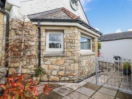 An outdoor area with a stone wall and window at Chapel Green Studio 2 in Polgooth