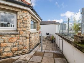 An outdoor area with a gate and stone wall at Chapel Green Studio 2 in Polgooth