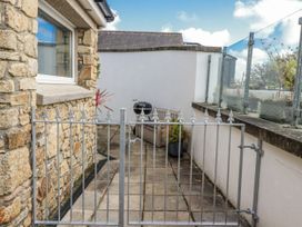 An outdoor patio with a gate and seating area at Chapel Green Studio 2 in Polgooth