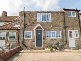 A stone house with a front door and windows at Fairhaven Cottage Ugthorpe near Runswick Bay