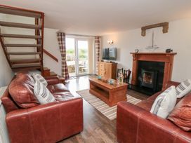 A living room with a sofa and coffee table at Fairhaven Cottage in Ugthorpe near Runswick Bay