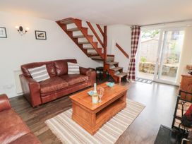 A living room with a sofa and coffee table at Fairhaven Cottage in Ugthorpe near Runswick Bay