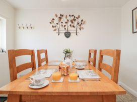 A dining room with a table set for breakfast at Fairhaven Cottage Ugthorpe near Runswick Bay