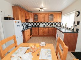 A kitchen with a table set for breakfast at Fairhaven Cottage Ugthorpe near Runswick Bay