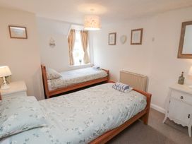 A bedroom with two single beds and a lamp at Fairhaven Cottage Ugthorpe near Runswick Bay