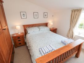A bedroom with a bed and bedside tables at Fairhaven Cottage in Ugthorpe near Runswick Bay