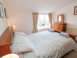 A bedroom with a double bed and a dressing table at Fairhaven Cottage near Runswick Bay