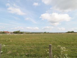 A field with sheep and a farmhouse at Fairhaven Cottage in Ugthorpe near Runswick Bay