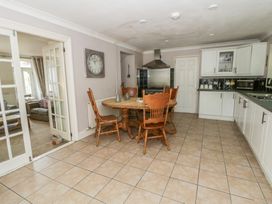 A kitchen with a round table and chairs at Teifi House in Cilgerran near Cardigan