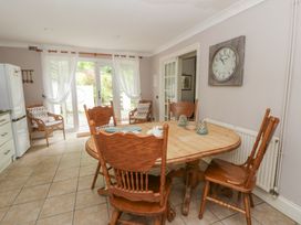A dining room with a round table and chairs at Teifi House in Cilgerran near Cardigan