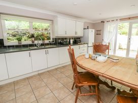 A kitchen with a dining table and chairs at Teifi House in Cilgerran near Cardigan