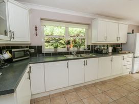 A kitchen with cabinets and countertop at Teifi House in Cilgerran near Cardigan