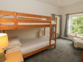 A bedroom with a bunk bed and a single bed at Teifi House in Cilgerran near Cardigan