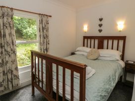 A bedroom with a bed and window at Teifi House in Cilgerran near Cardigan