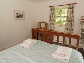 A bedroom with a bed and dressing table at Teifi House in Cilgerran near Cardigan