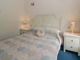 A bedroom with a bed and bedside tables at Teifi House near Cilgerran Cardigan