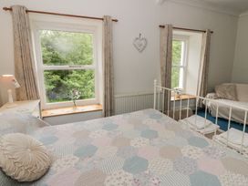 A bedroom with a bed and window at Teifi House in Cilgerran near Cardigan