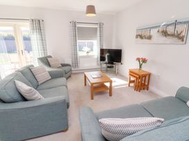 A living room with a television and seating area at The Haven in Embleton