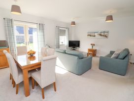 A living room with a TV and a dining area at The Haven in Embleton