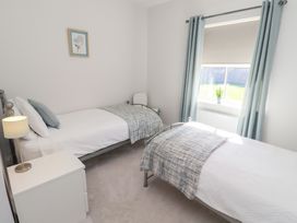 A bedroom with two single beds and a window at The Haven in Embleton