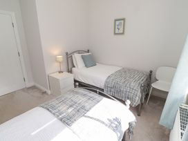 A bedroom with two beds and a nightstand at The Haven in Embleton
