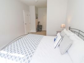 A bedroom with a bed and a chair at The Haven in Embleton