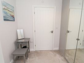 A bedroom with a table and mirror at The Haven in Embleton