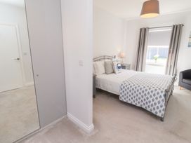 A bedroom with a bed and nightstand at The Haven in Embleton
