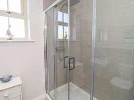 A bathroom with a shower enclosure and decorative items at The Haven in Embleton