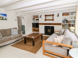 A living room with a sofa and coffee table at Fern Cottage in Aberporth
