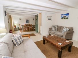A living room with a sofa and coffee table at Fern Cottage in Aberporth
