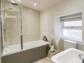 A bathroom with a bathtub and shower at Fern Cottage Aberporth