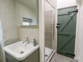 A bathroom with a sink and shower at Fern Cottage in Aberporth