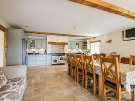 A kitchen with a dining table and chairs at The Hayloft in Bleddfa near Knighton