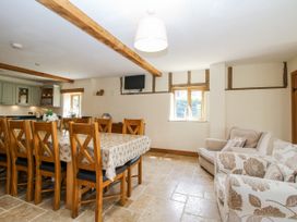 A dining room with a table and chairs at The Hayloft in Bleddfa near Knighton