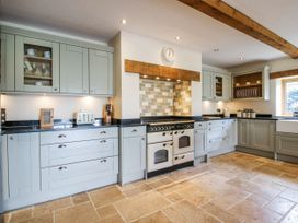 A kitchen with cabinets and appliances at The Hayloft in Bleddfa near Knighton
