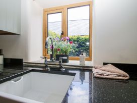 A kitchen with a sink and window at The Hayloft in Bleddfa near Knighton