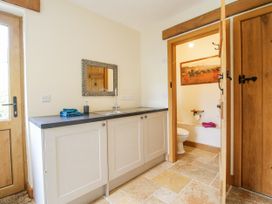 A bathroom with a mirror and sink at The Hayloft in Bleddfa near Knighton
