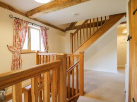 A hallway with a staircase and window at The Hayloft Bleddfa near Knighton