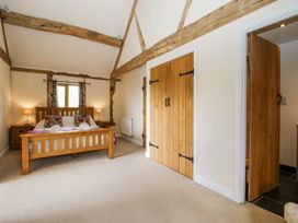 A bedroom with a bed and nightstands at The Hayloft in Bleddfa near Knighton