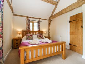A bedroom with a bed and nightstand at The Hayloft Bleddfa near Knighton