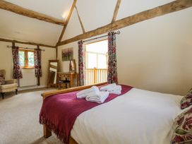 A bedroom with a bed and a dressing table at The Hayloft in Bleddfa near Knighton