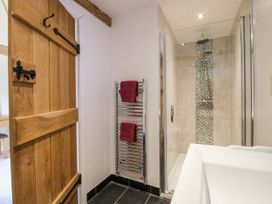 A bathroom with a shower and towel rack at The Hayloft in Bleddfa near Knighton