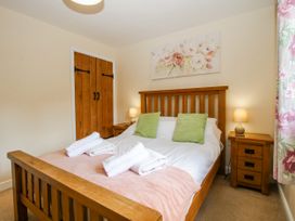 A bedroom with a bed and bedside table at The Hayloft in Bleddfa near Knighton