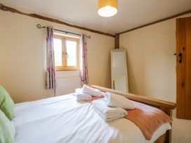 A bedroom with a bed and towels at The Hayloft in Bleddfa near Knighton