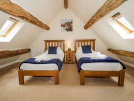A bedroom with two single beds and a skylight at The Hayloft in Bleddfa near Knighton